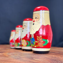 Load image into Gallery viewer, Vintage Christmas. 4 piece Nesting wooden Santa dolls.
