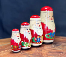 Load image into Gallery viewer, Vintage Christmas. 4 piece Nesting wooden Santa dolls.
